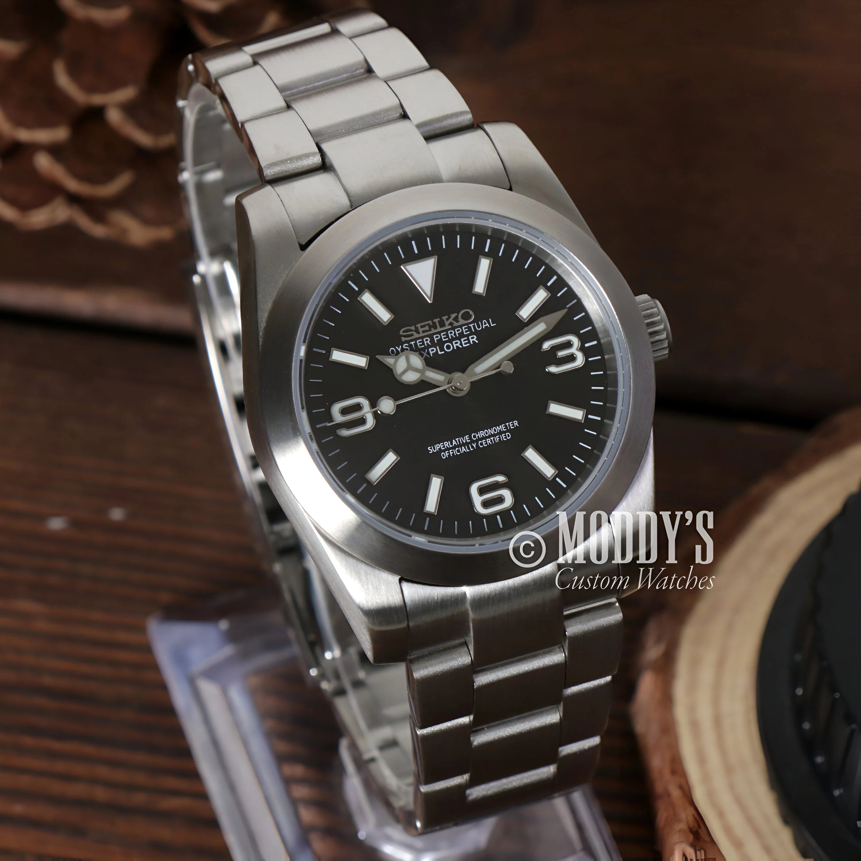 Stainless steel Oysteiko Black Explorer watch featuring a black dial and Arabic numerals