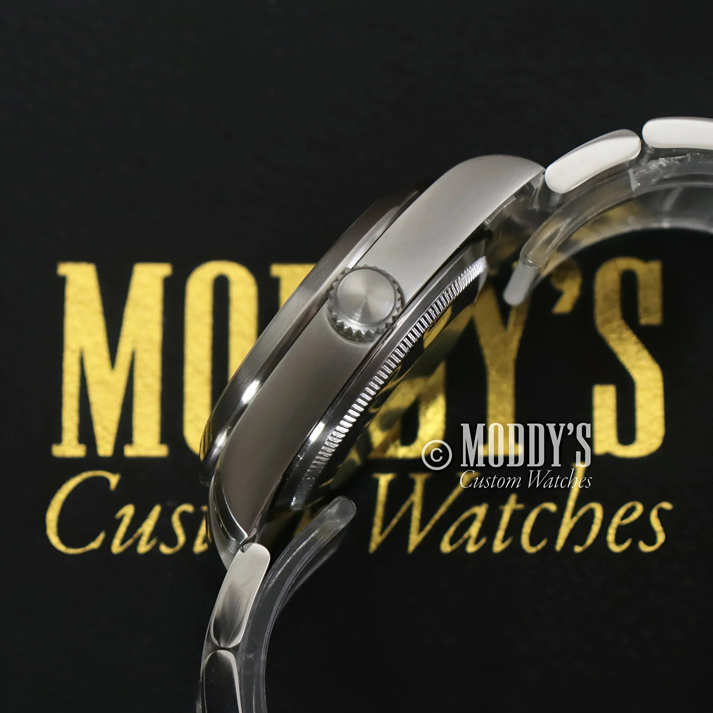 Silver wristwatch with fluted bezel from Oysteiko Explorer Black featuring NH35 automatic movement