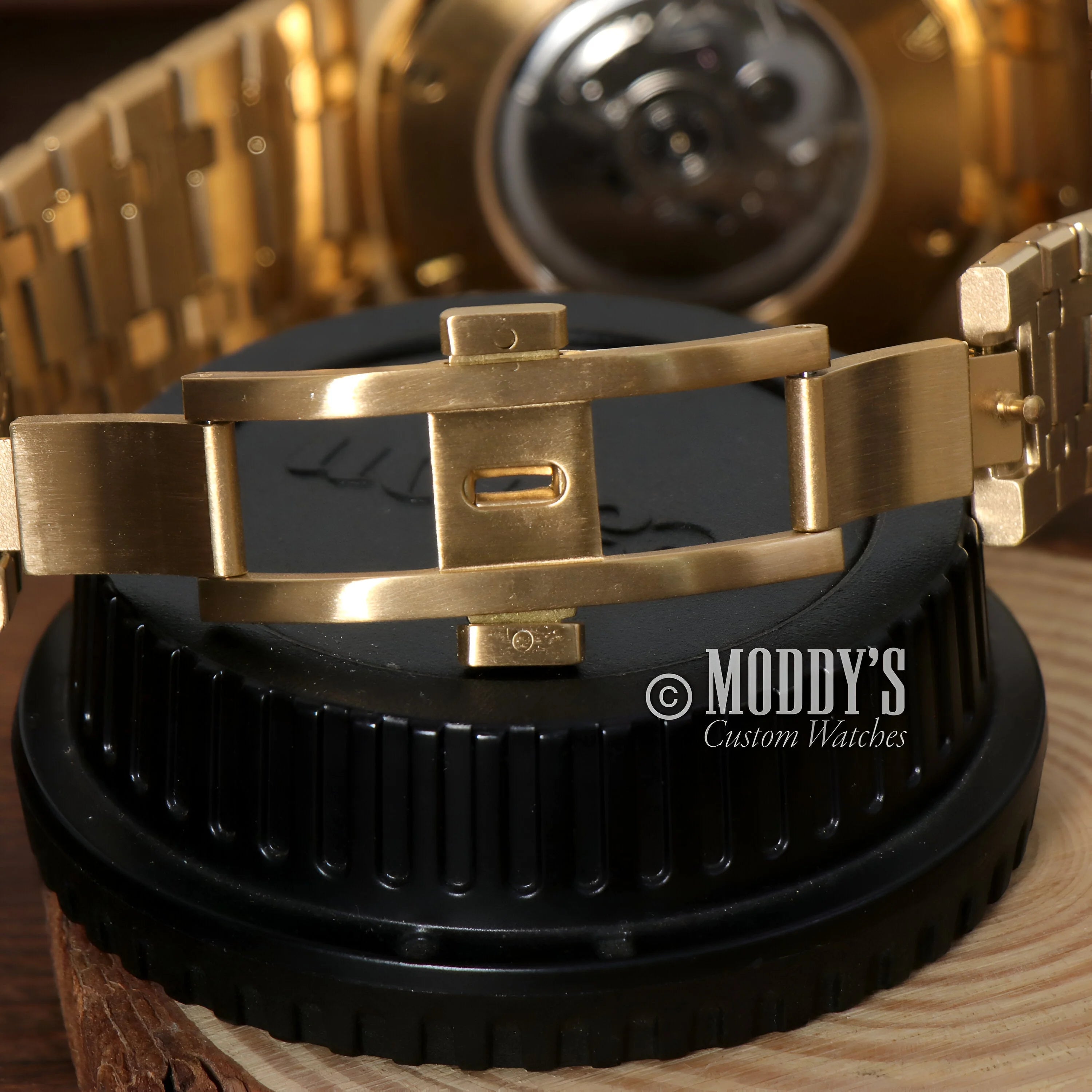 Gold-toned deployment buckle of the Royal Seikoak Black watch showcasing luxury design