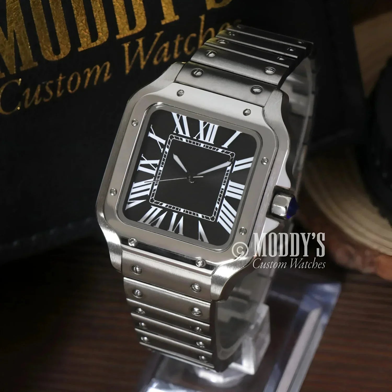 Silver wristwatch with black face featuring NH35 automatic movement and 316L stainless steel