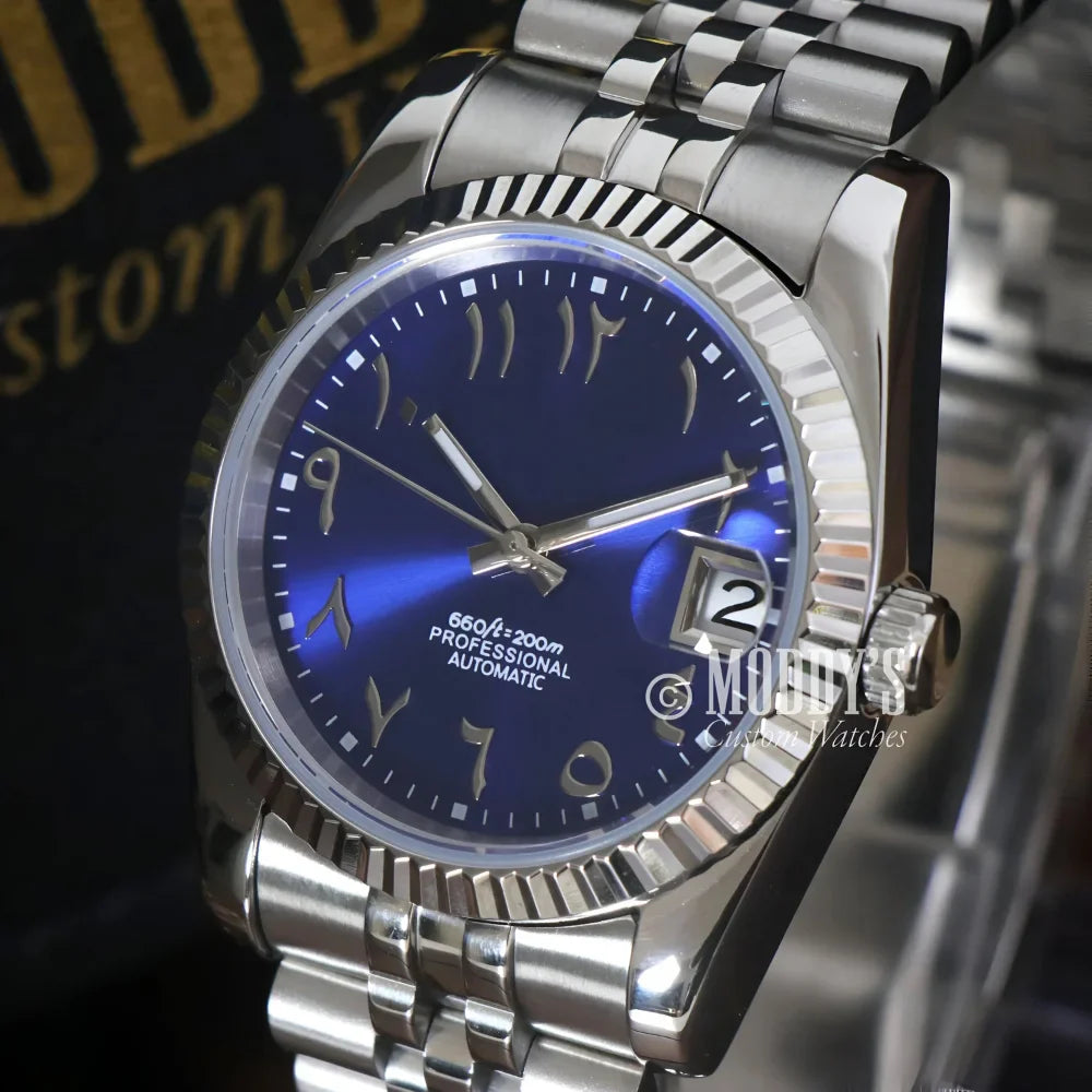 Silver Seiko Mod wristwatch with blue Arabic numeral dial, featuring Seiko NH35 Automatic
