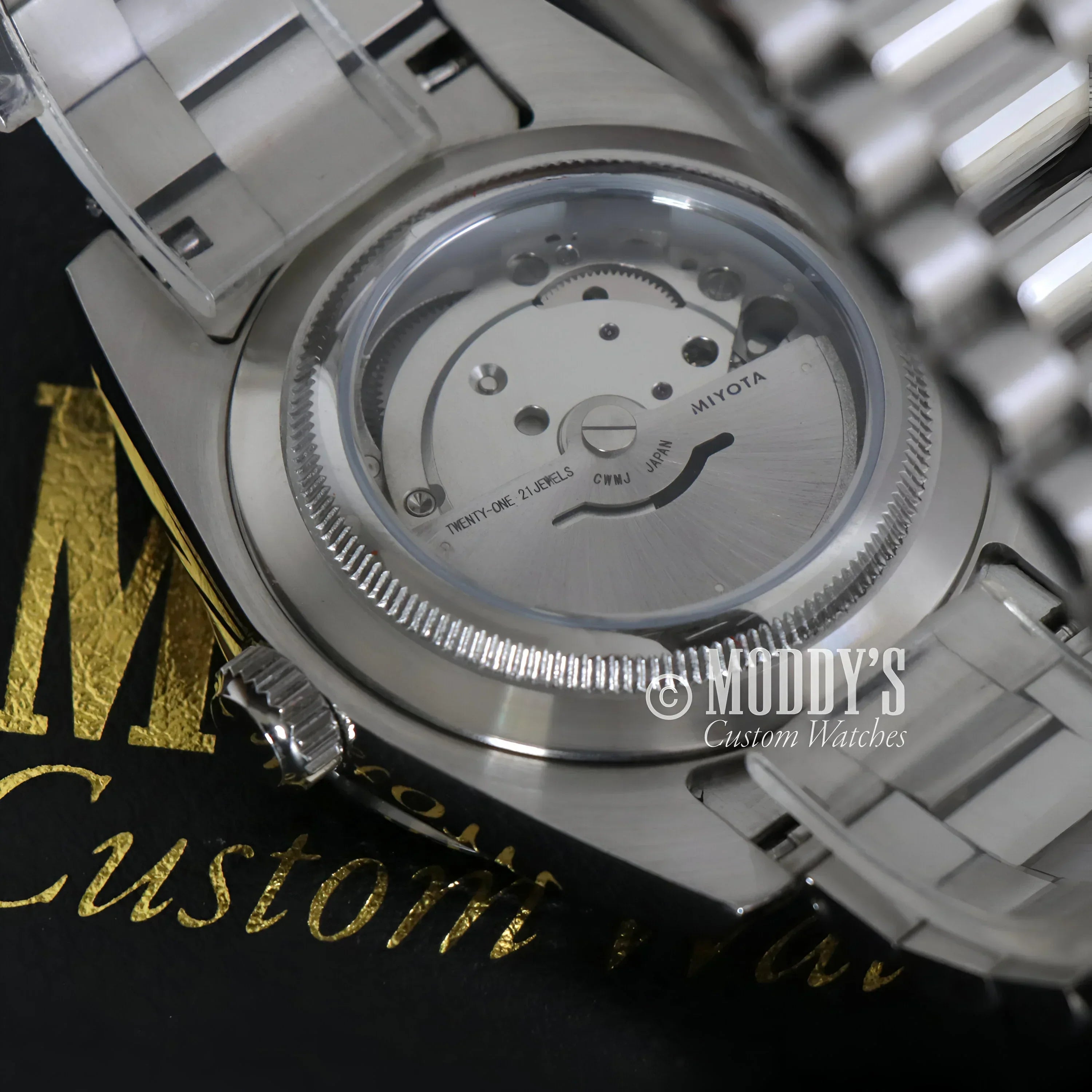 Silver Seiko Mod wristwatch with visible movement in Daydate Arabic Deep Grey design