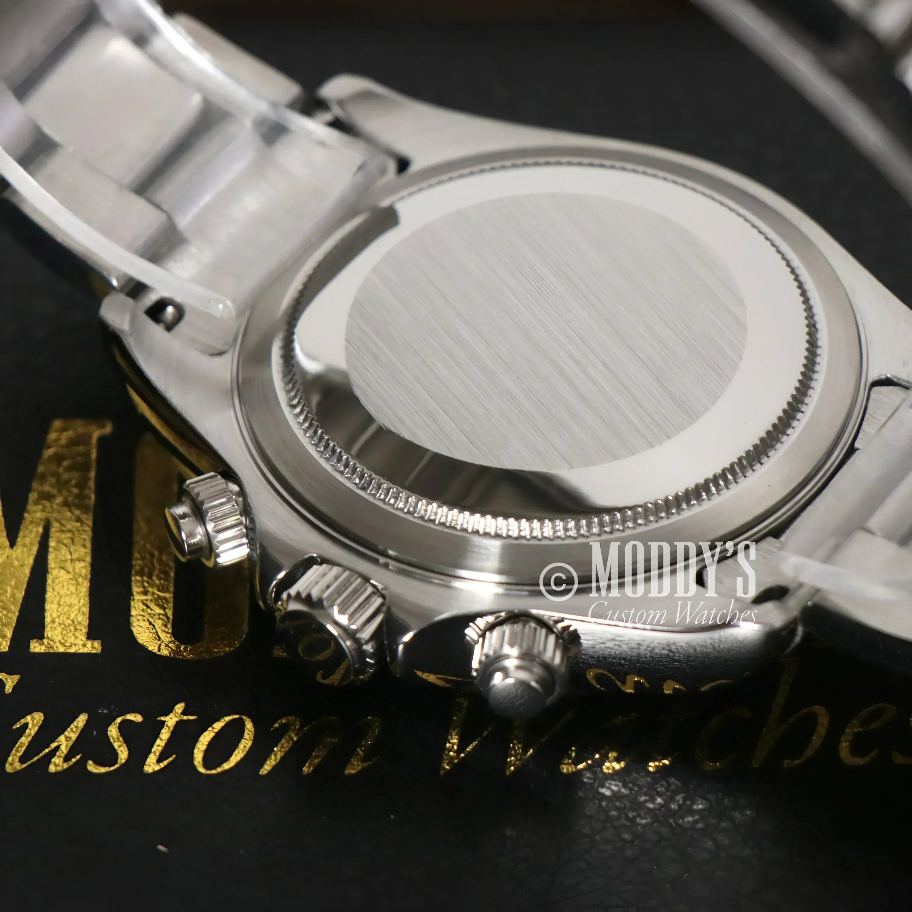 Silver wristwatch back of Seitona Panda with Seiko VK63 hybrid movement