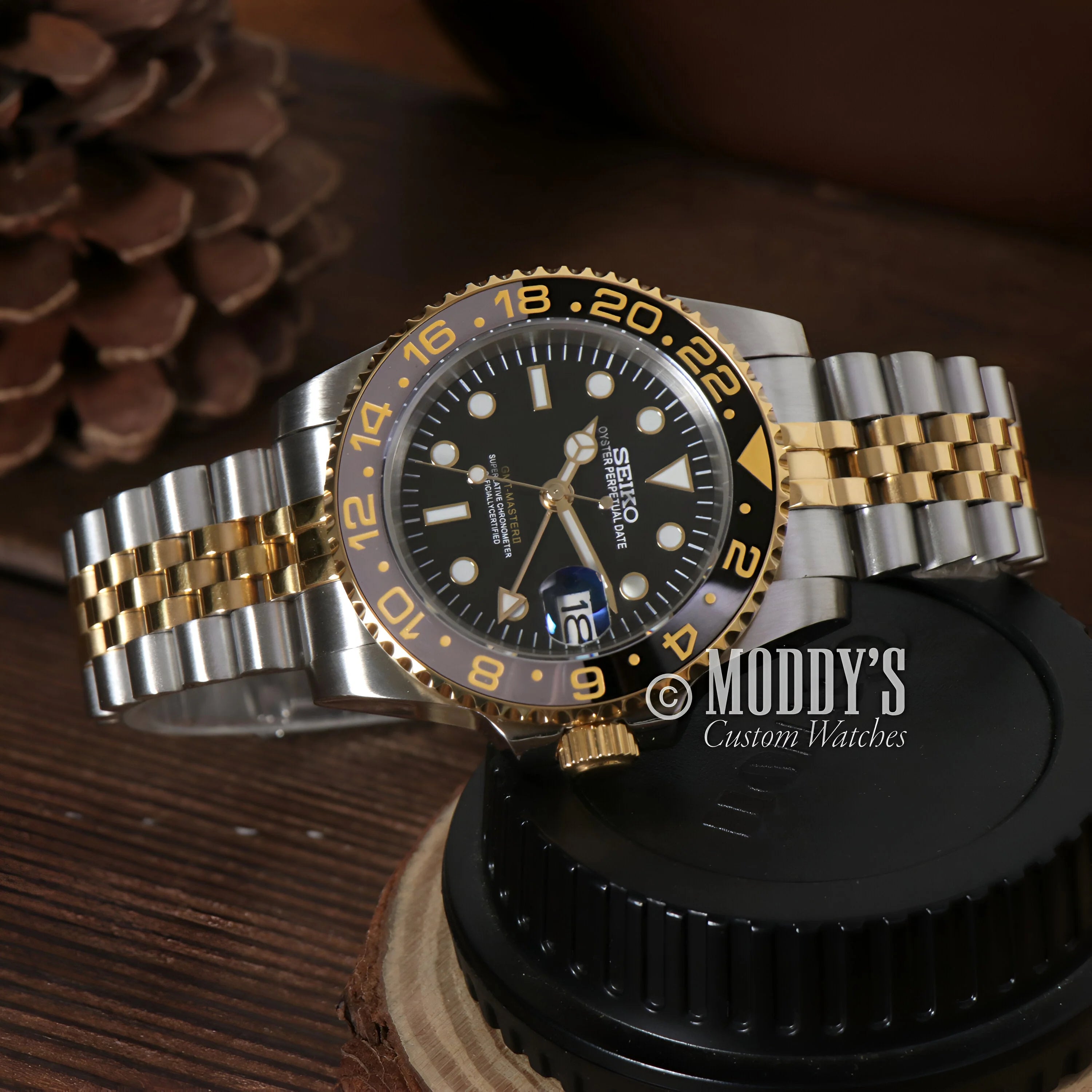 Two-tone Rolex GMT-Master II watch with black dial, 904L stainless steel and gold accents