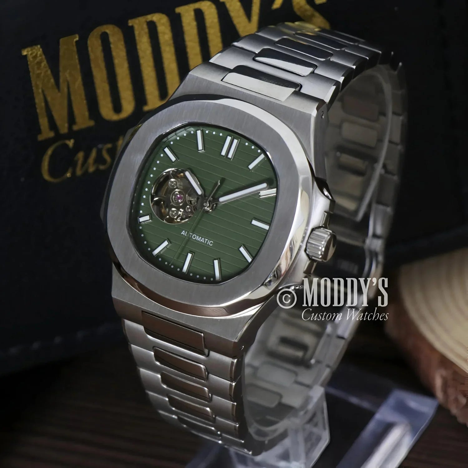Silver wristwatch with green face featuring NH38 automatic movement, Nautiko design