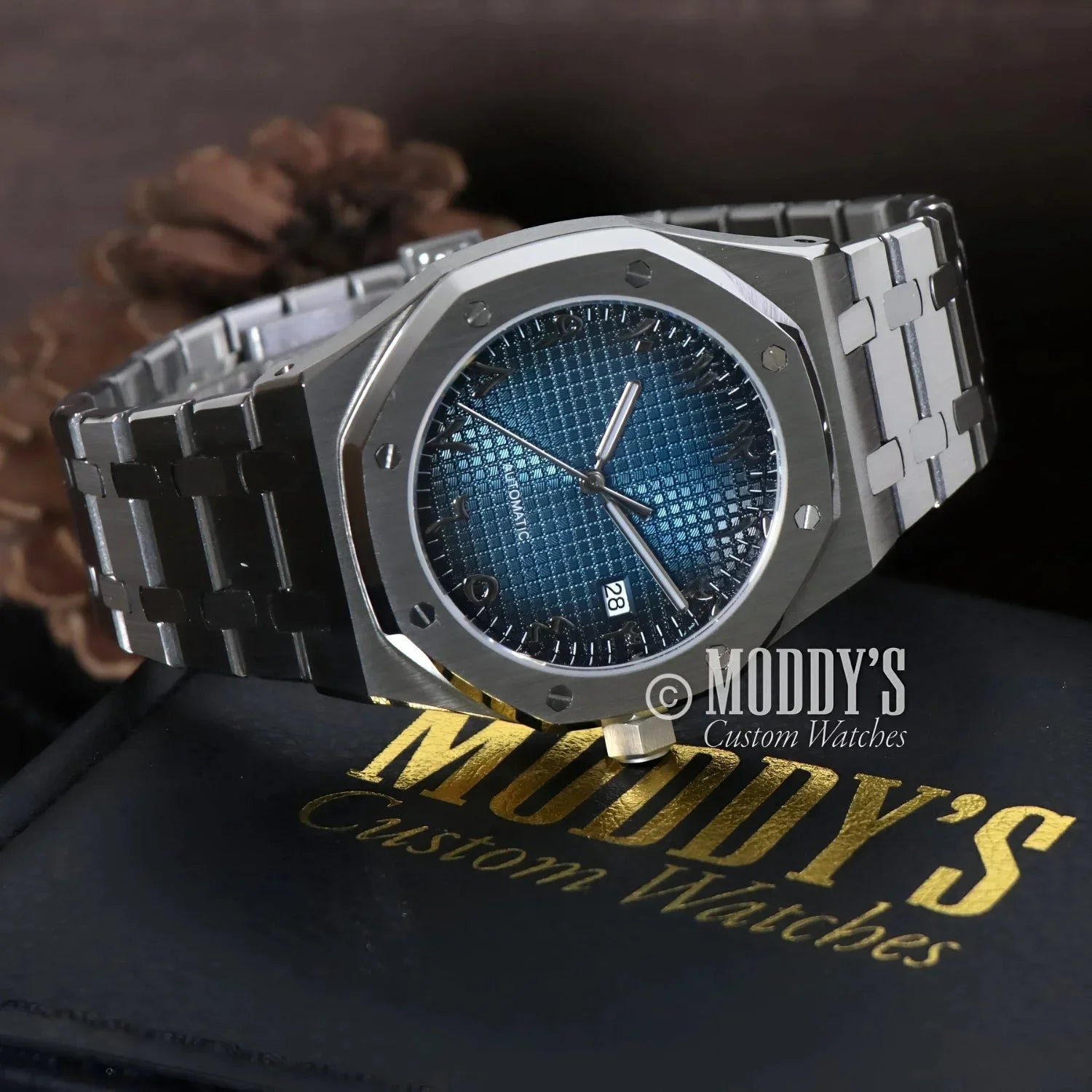 Silver-toned wristwatch with blue patterned face from Royal Seikoak Arabic Blue collection