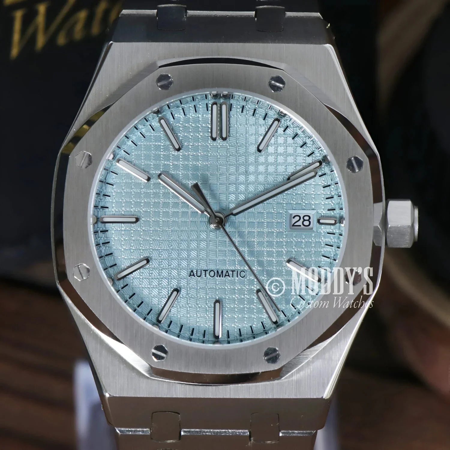 Silver-tone automatic wristwatch with light blue patterned dial, featuring NH35 movement, Ice Blue