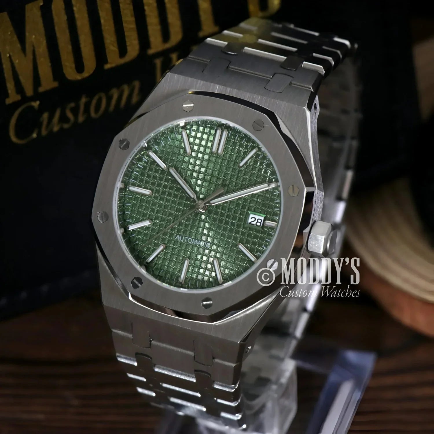 Silver wristwatch with olive green face from Royal Seikoak, a stylish Seiko mod royal