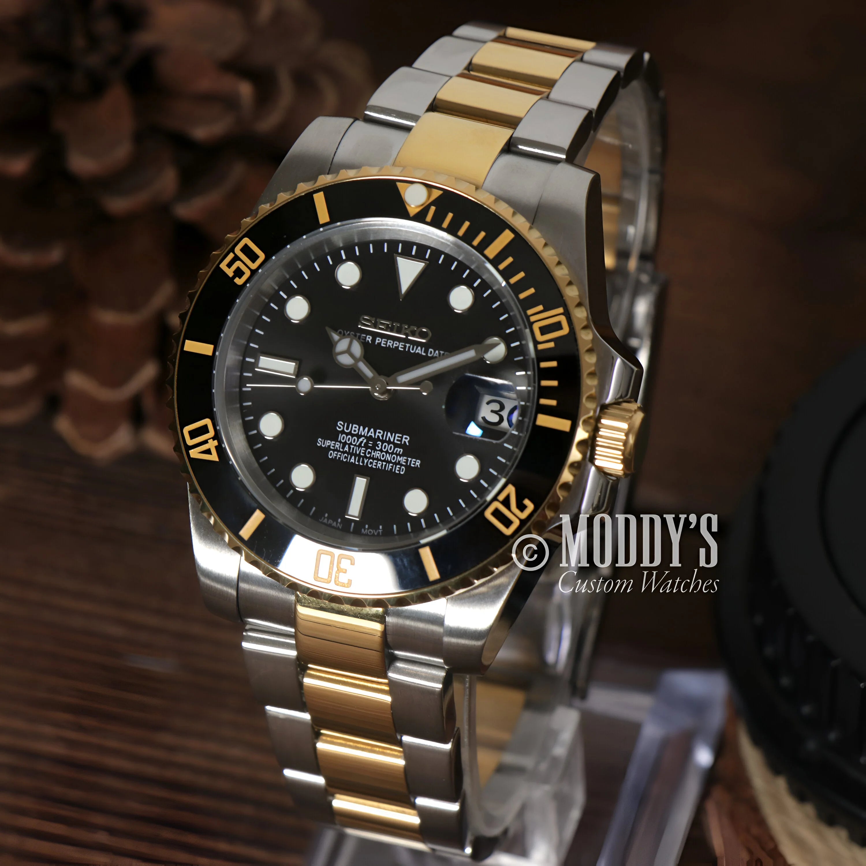 Luxury Seiko Mod Submariner with black dial and two-tone gold and silver bracelet