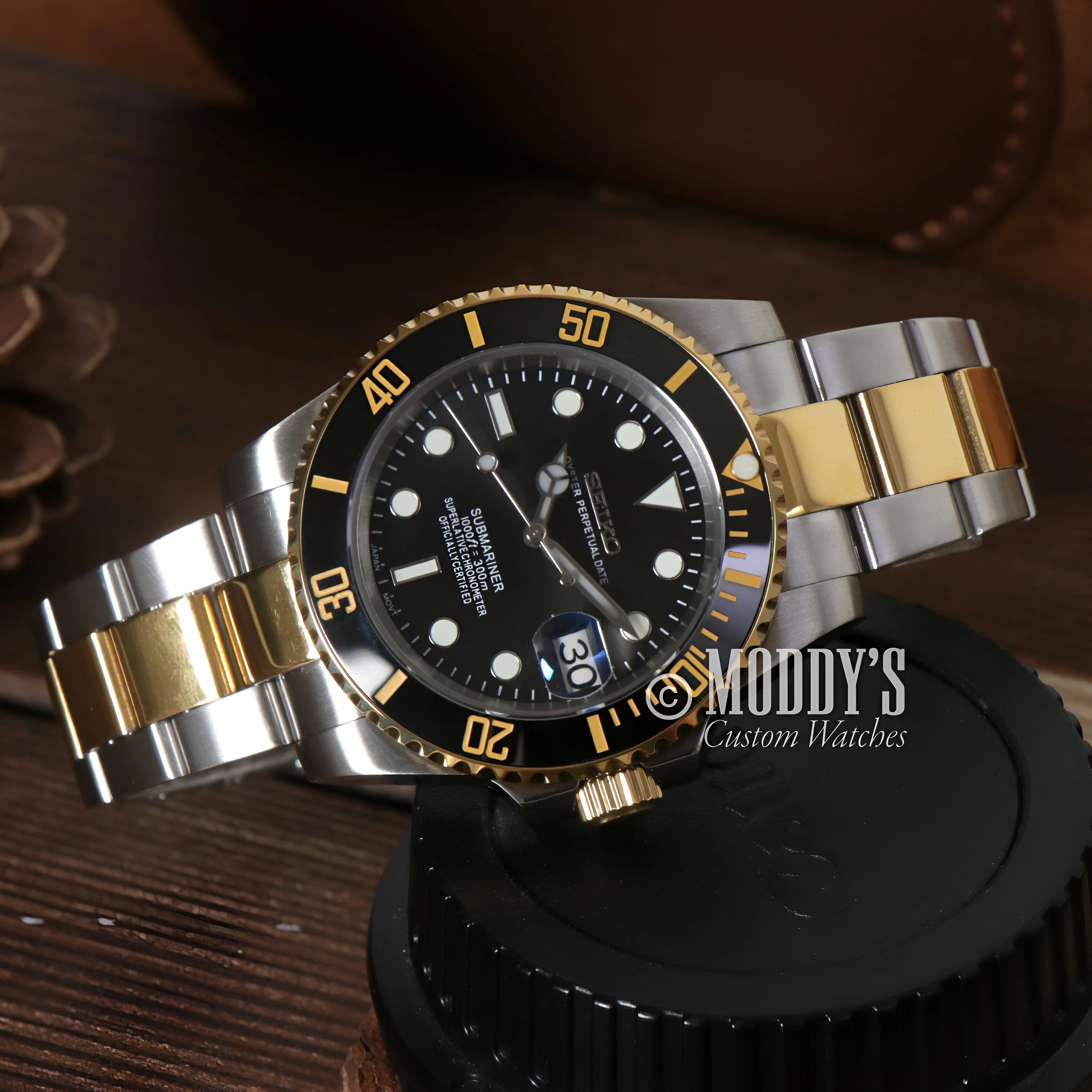 Two-tone gold and silver Rolex Submariner wristwatch in Seikomariner Black mod style