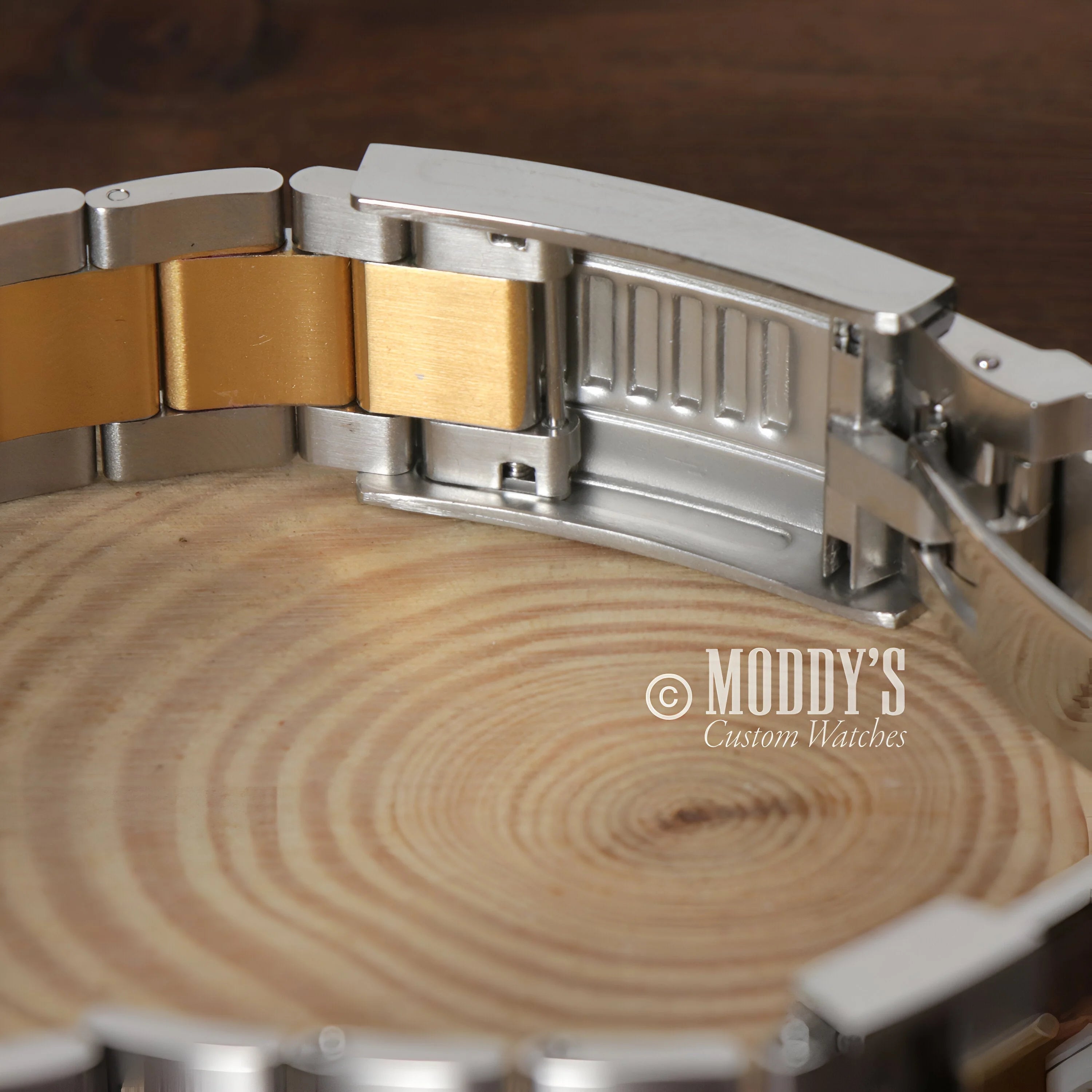 Seiko Mod Submariner with a stylish silver and gold-toned metal bracelet links