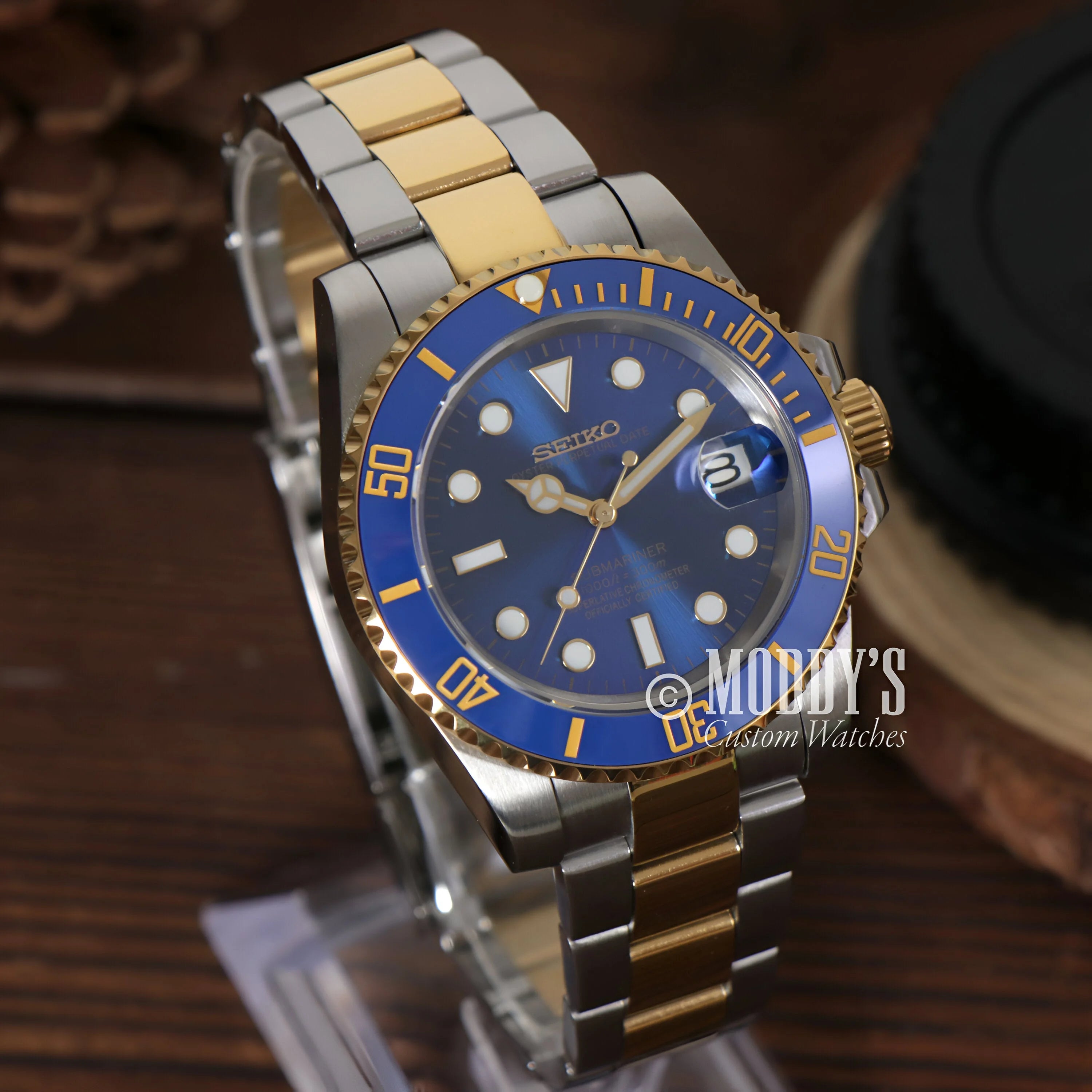 Two-tone Seiko Mod Submariner wristwatch with blue dial and bezel, gold and silver links