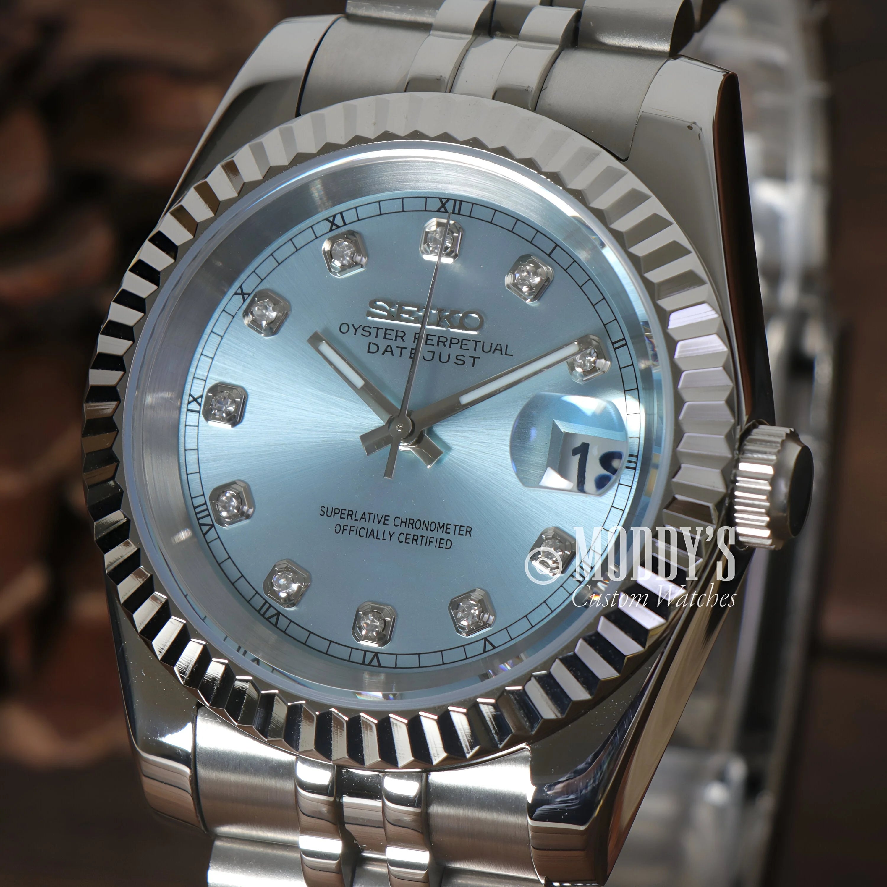 Luxury Rolex wristwatch with light blue dial, diamond markers, and iconic Datejust design