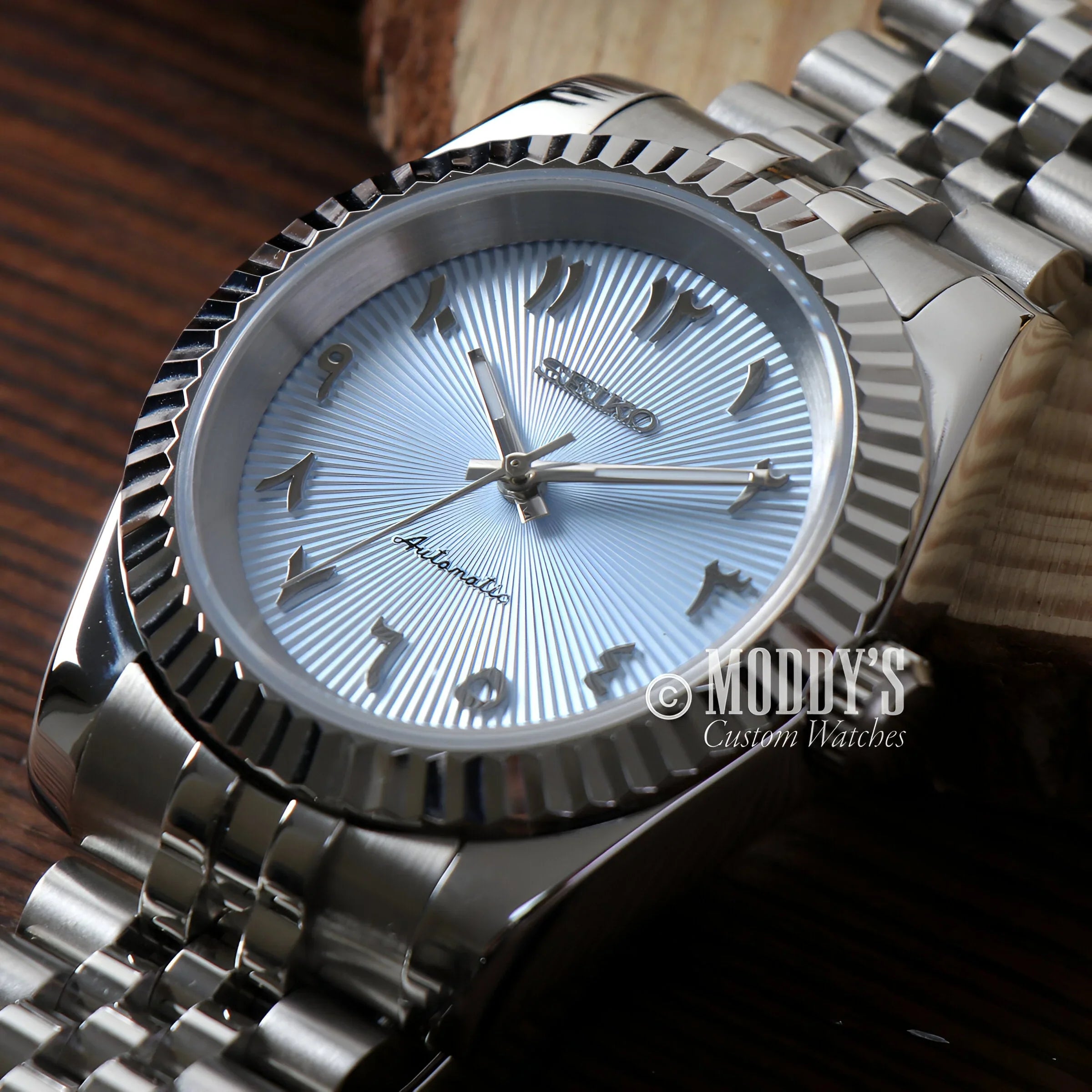 Seikojust Light Blue Nh35 Watch Close-up On Table Next To Wooden Box, Automatic Movement