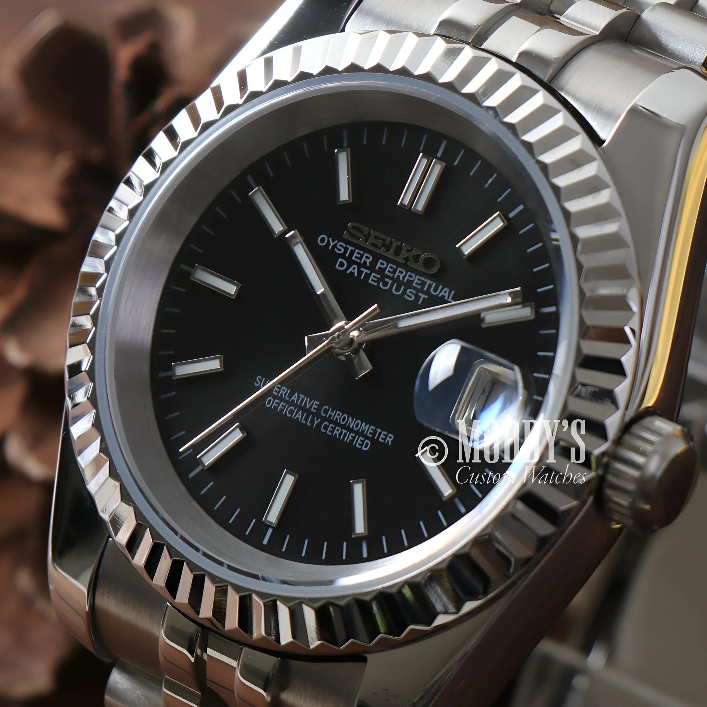 Seikojust Black Watch With Black Dial, Silver Bracelet, And Sleek Datejust Case Design