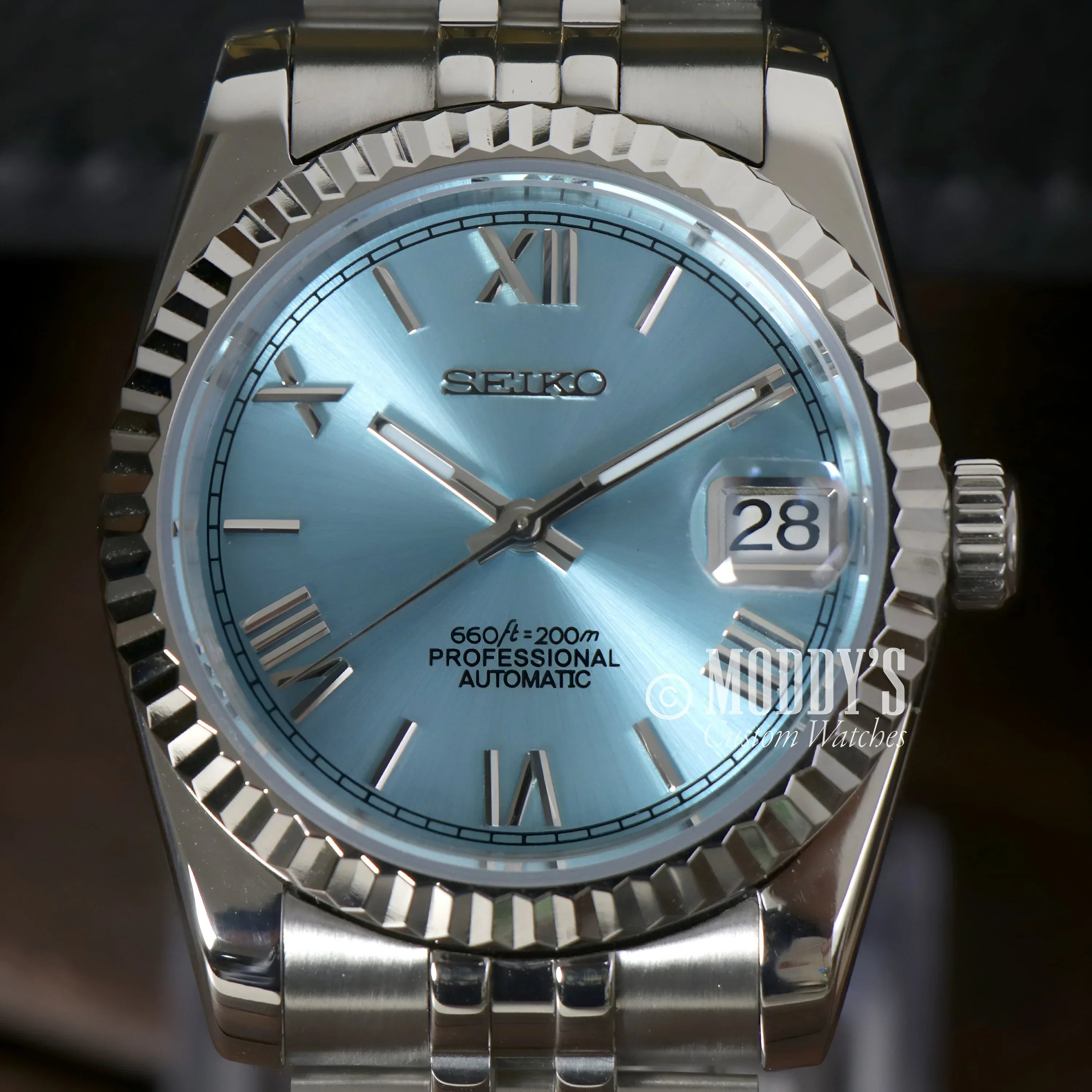 Silver Seiko wristwatch with ice blue Roman face and NH35 automatic movement