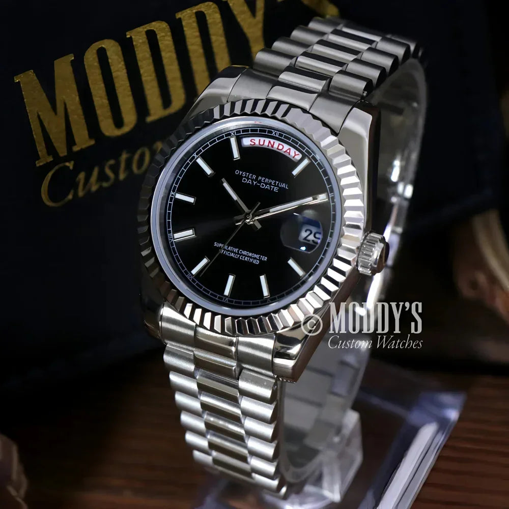 Silver wristwatch with black face from Seikojust Daydate Classic Black in 904L stainless steel