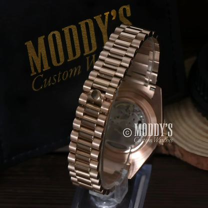 Rose gold watch with metal band from Seikojust, featuring Daydate Rose Gold design