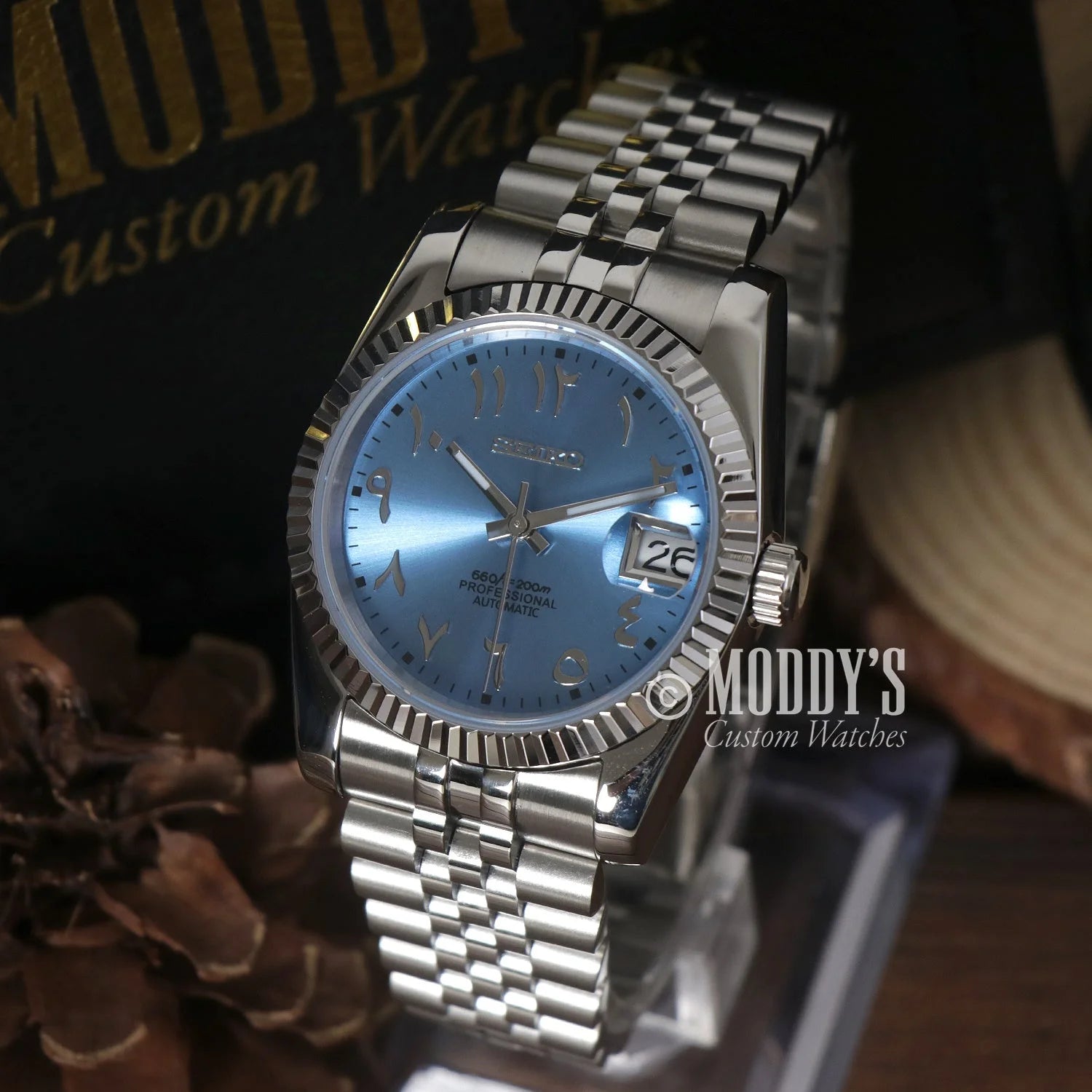 Stainless steel Seiko Mod Datejust with fluted bezel and light blue dial on jubilee bracelet