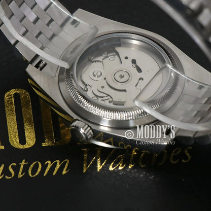 Silver wristwatch with exposed NH35 automatic movement, Seiko Mod Datejust Ice Blue Roman