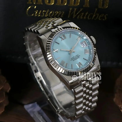 Silver wristwatch with light blue face from Seikojust Ice Blue Roman featuring NH35 automatic movement