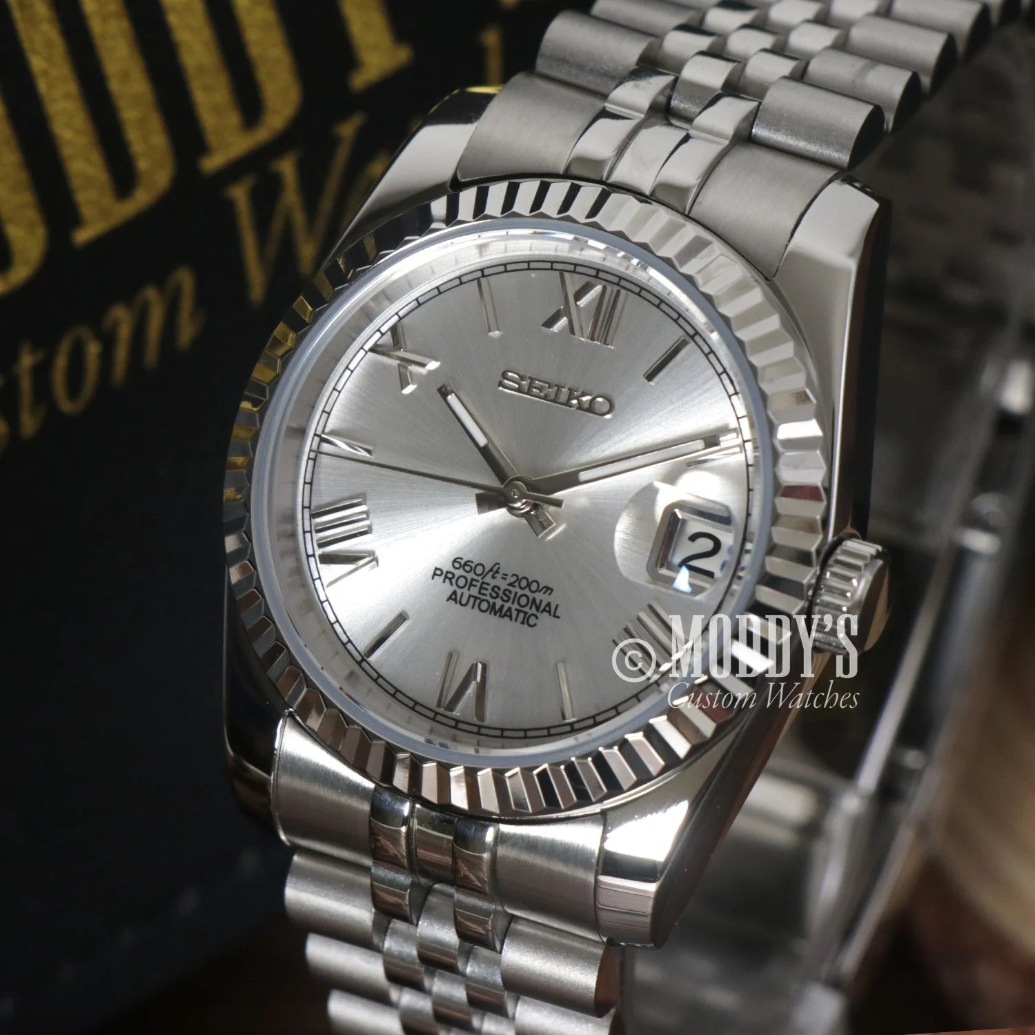 Silver Seiko wristwatch with Roman numerals and fluted bezel, ideal for Seiko Mod Datejust