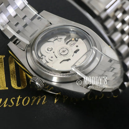 Silver wristwatch with visible gears featuring NH35 automatic movement by prestigious Seiko