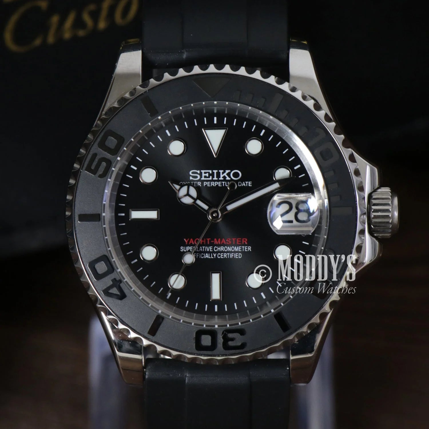 Black-dialed Seiko dive watch with rotating bezel, date window in Seikomarine Black mod