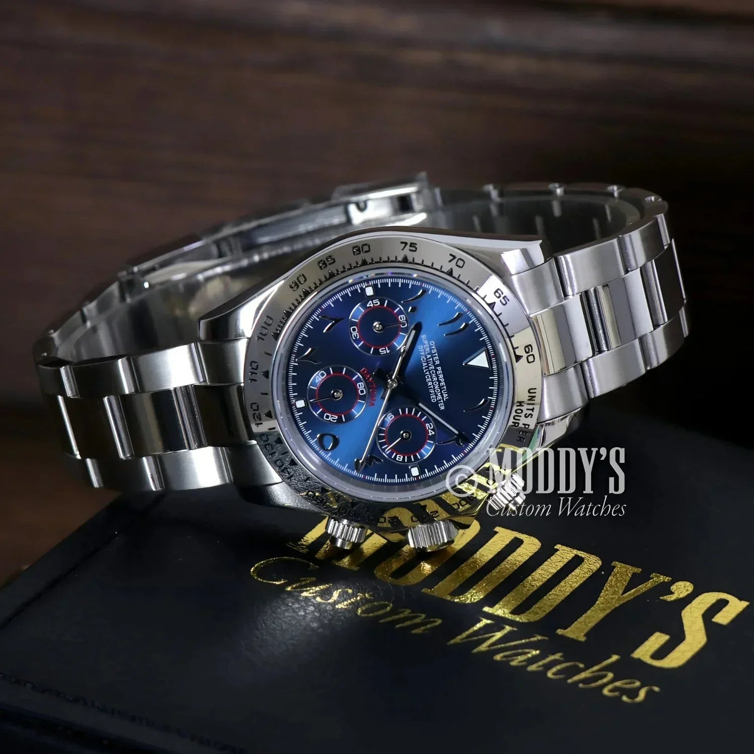 Silver chronograph wristwatch with blue face featuring Seiko VK63 hybrid movement