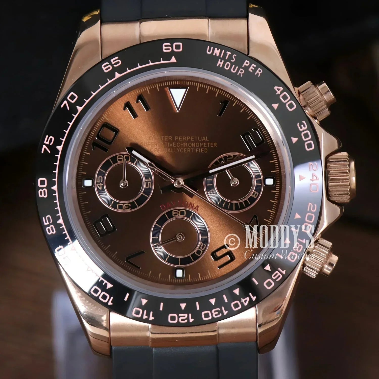 Rose gold Rolex Daytona watch with brown dial, black bezel, featuring Seiko VK63 hybrid movement