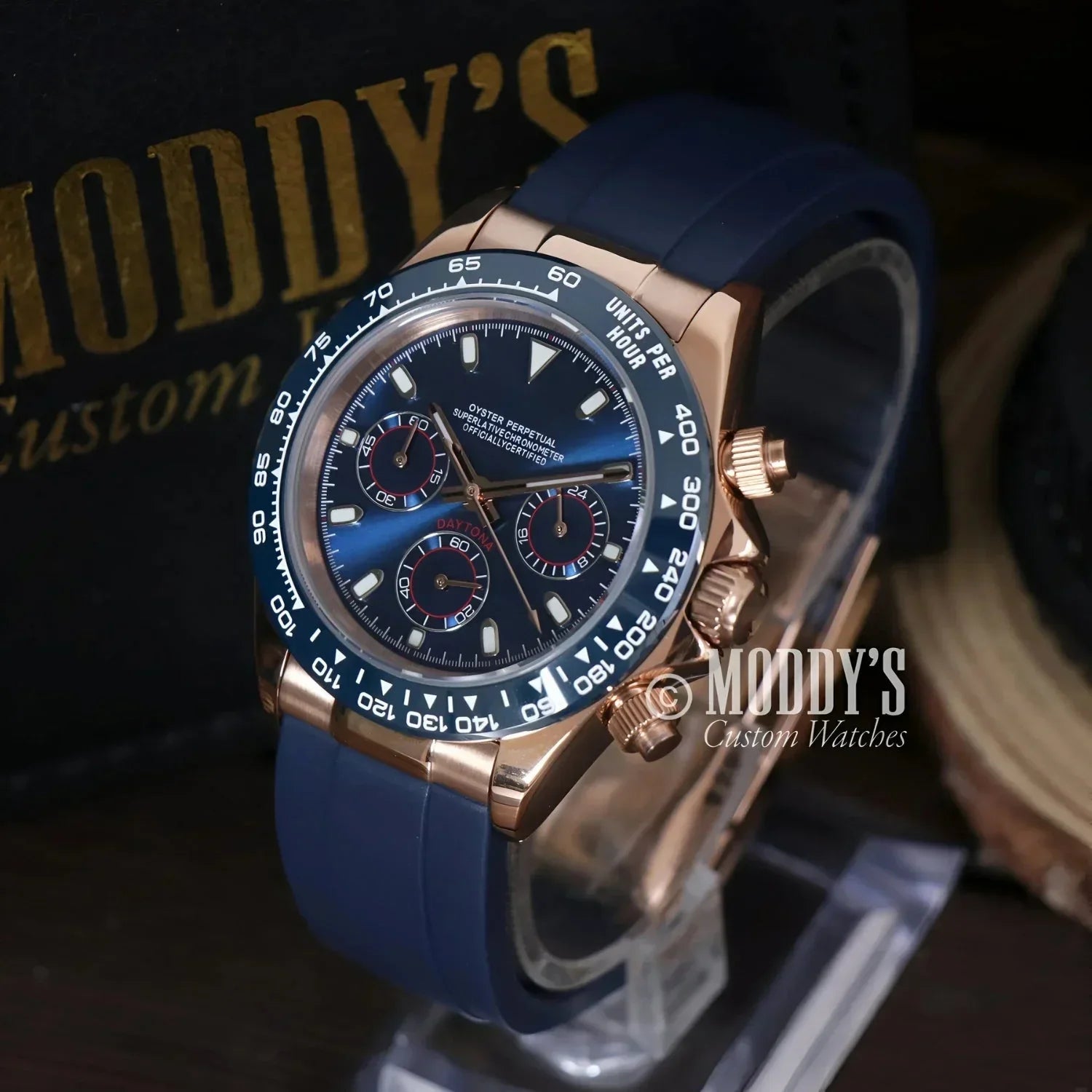 Rose gold chronograph wristwatch with blue band, featuring Seiko VK63 hybrid movement